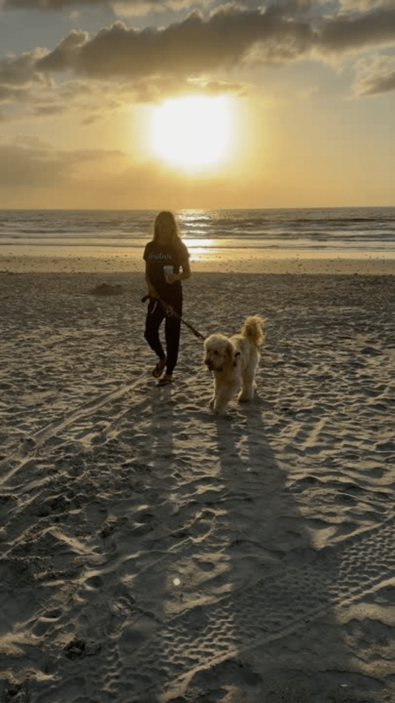 Robin and Hollywood walking on Cocoa Beach during dog-friendly beach hours